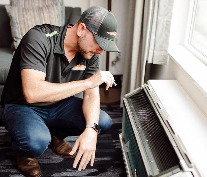 A highly skilled technician examines the HVAC system to see where it's malfunctioning. 