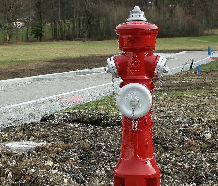 A red fire hydrant on sidewalk 