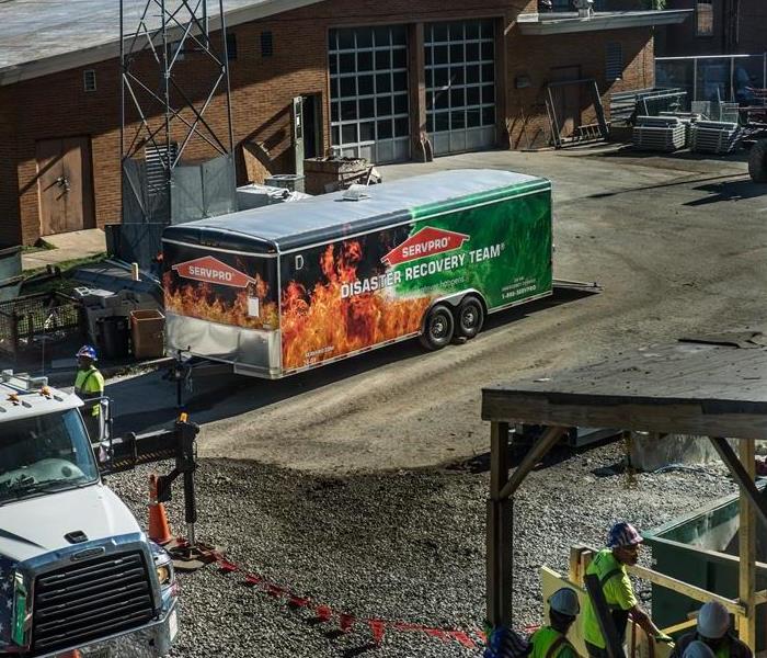 The SERVPRO team is gathered in the back of a building assembling all of their items to help your business go back to normal!