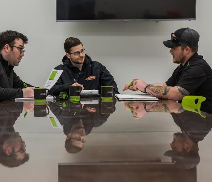Our SERVPRO team sits around a conference table to discuss ways to make it "Like it never even happened."