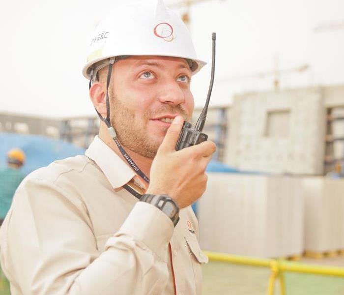 contractor talking into a walkie-talkie