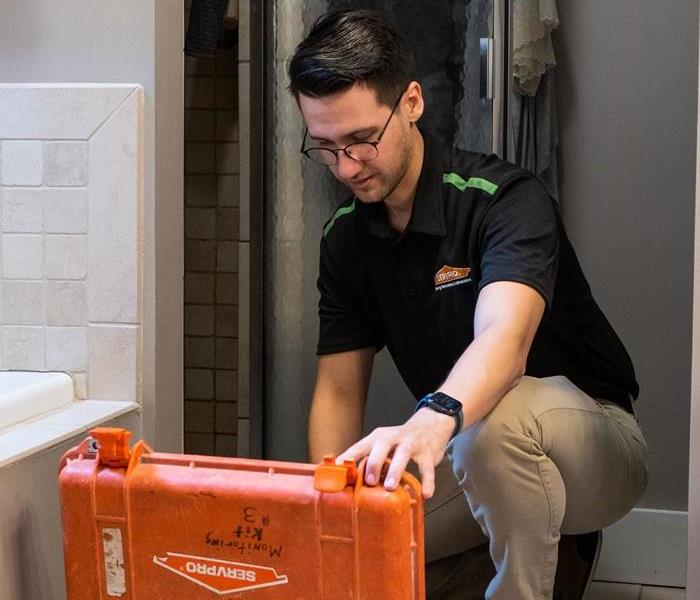 SERVPRO employee preparing to fix pipes