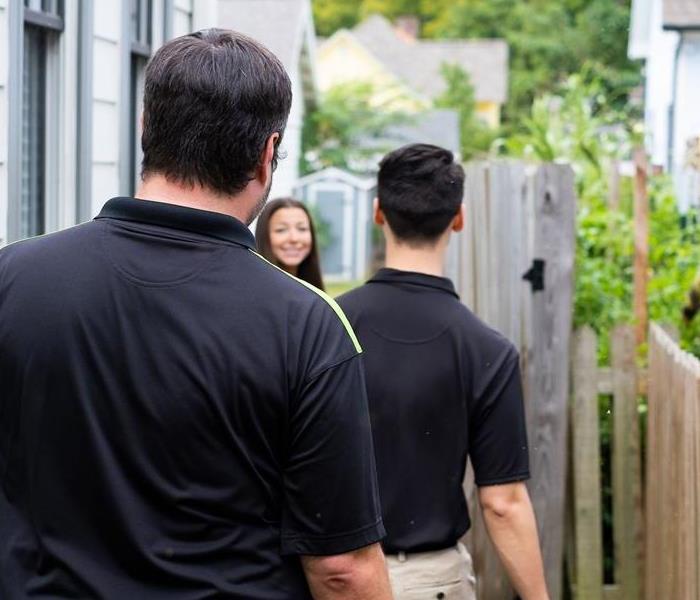 SERVPRO employees meeting with customer outside their home, ready to evaluate smoke damage